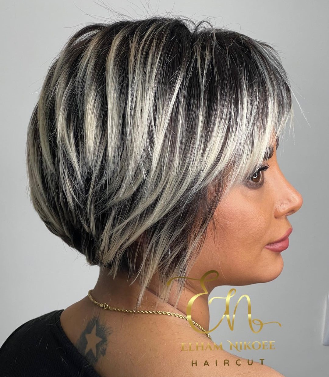 Short Sliced Black Bob with White Highlights